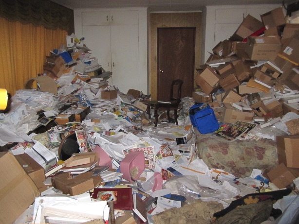 Hazel Park room filled with papers, boxes, and magazines before a cleanout